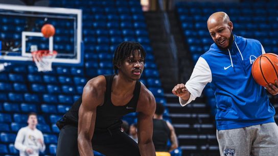 Saint Louis Guard Amari McCottry works on a dribbling drill with Coach Antone Gray Saint Louis Guard Amari McCottry works on a dribbling drill with Coach Antone Gray