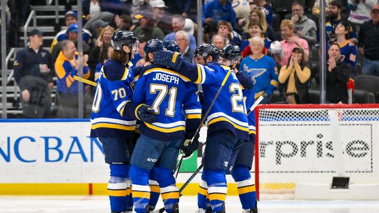 Feb 25, 2025; St. Louis, Missouri, USA; St. Louis Blues right wing Mathieu Joseph (71) is congratulated by teammates after scoring against the Seattle Kraken during the third period at Enterprise Center.