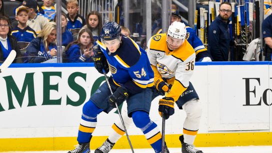 St. Louis Blues center Dalibor Dvorsky (54) controls the puck while being defended by Nashville Predators left wing Cole Smith (36) during the second period at Enterprise Center on March 23, 2025.