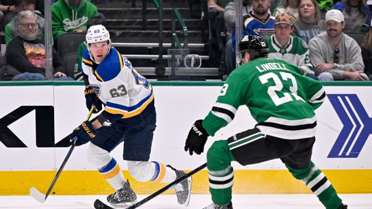St. Louis Blues left wing Jake Neighbours skates with the puck past Dallas Stars defenseman Esa Lindell during the first period at American Airlines Center on March 2, 2025, in Dallas, Texas.