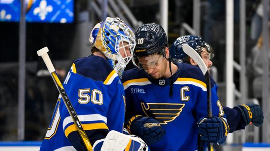 Jordan Binnington and Brayden Schenn celebrate Blues' win over Ducks at Enterprise Center.