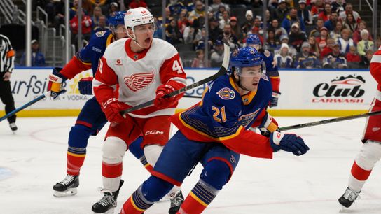 St. Louis Blues right wing Jimmy Snuggerud (21) skates against Detroit Red Wings right wing Jonatan Berggren (48) during the first period at Enterprise Center on April 1, 2025.