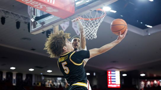 Missouri guard T.O. Barrett (5) attempts a shot over Oklahoma's Brycen Goodine (2) in the first half at Lloyd Noble Center.