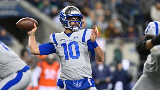 AJ McCarron throwing a football