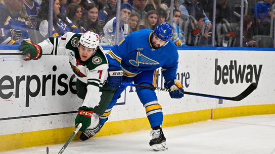 Mar 16, 2024; St. Louis, Missouri, USA; St. Louis Blues defenseman Nick Leddy (4) defends against Minnesota Wild defenseman Brock Faber (7) during the first period at Enterprise Center. 